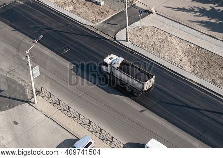 Truck With A Breakstone On A Road In The City During Road Construction Work.