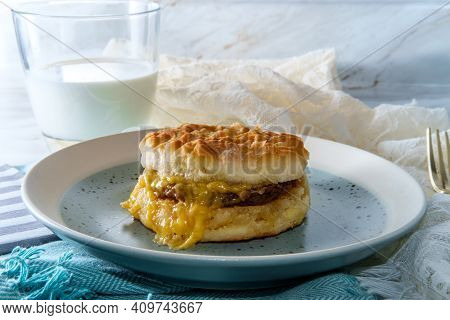 Sausage Egg And Cheese Biscuit Breakfast Sandwich With Glass Of Milk