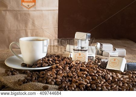 Tiraspol, Moldova - February 23, 2021: Cup Of Coffee, Coffee Beans And Barista Sweets On Sackcloth,