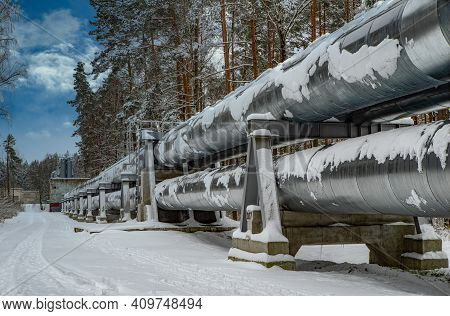 Huge Industrial Pipelines Of Central Heating System. Snow On Pipes.