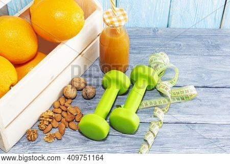 Lots Of Oranges And A Bottle Of Juice, Measuring Tape On A Wooden Textured Background. Fitness, Spor