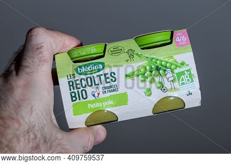 Paris, France - Feb 7, 2021: Pov Male Hand Holding Looking At The Bledina Biologique First Vegetable
