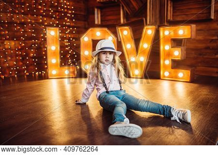 A Girl Wearing A Hat. Portrait. Smile. Decorated Letters Love