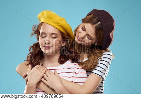 Mom And Daughter Striped T-shirts Hugs Fun Lifestyle Blue Background