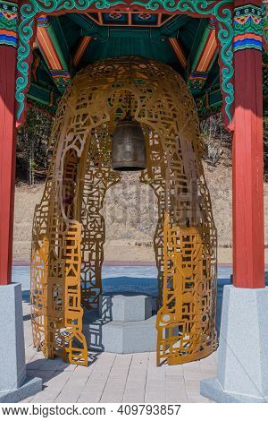 Chungbuk, South Korea;feb.21, 2021: Bronze Bell In Housing Sculpted From Metal Shaped In Korean Alph