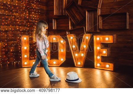 A Girl Wearing A Hat. Portrait. Decorated Letters Love