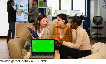 International Business Team Talking To African Woman Discussing Company Plan With Mockup Laptop In F