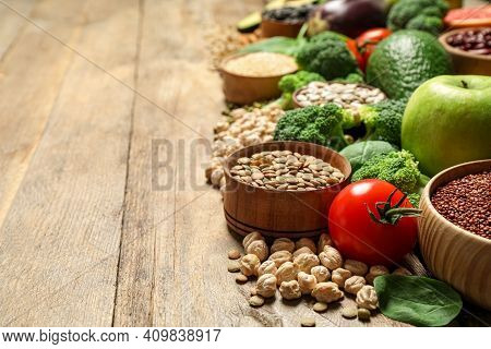 Different Vegetables, Seeds And Fruits On Wooden Table, Space For Text. Healthy Diet