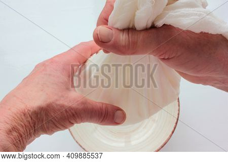 Old Woman Hands Holding A Homemade Cottage Cheese In Cloth On White Background. Ricotta Cheese Makin