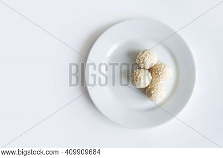 Raw Vegan Healthy Dessert, Coconut Bliss Balls On White Plate Isolated On White Background. Top View
