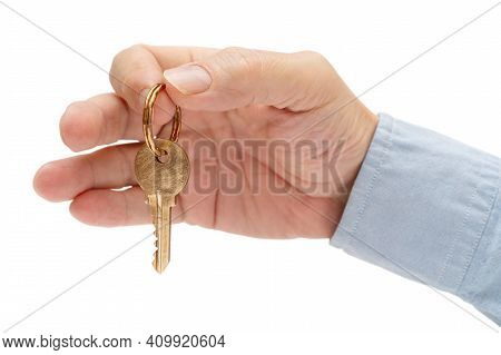 Apartment Key In A Man's Hand. Brass House Door Lock Key.