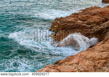 Sea Waves With Splashes Hit The Coastal Rocks