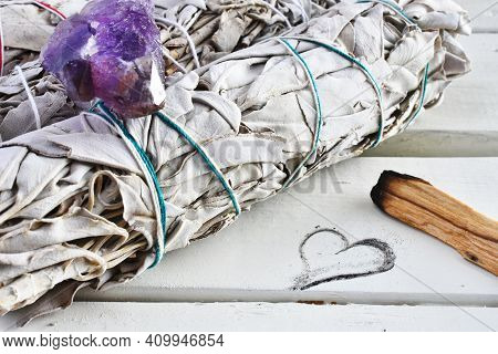 A Close Up Image Of Healing White Sage Smudge Bundles White Healing Crystals On A White Table Top.