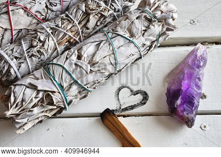 A Close Up Image Of Healing White Sage Smudge Bundles White Healing Crystals On A White Table Top.