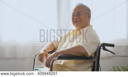 Portrait Asian Happy Face Senior Old Man Sitting In Wheelchair Smiling In Nursing Home, Closeup Disa