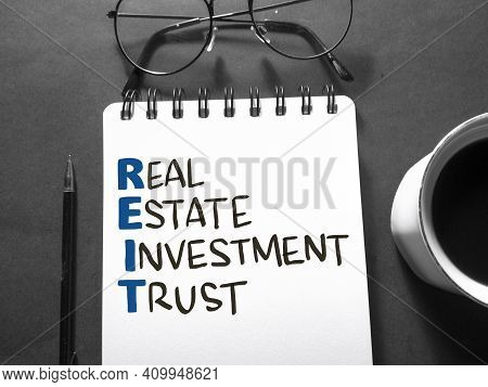 Reit Real Estate Investment Trust, Text Words Typography Written On Book Against Dark Background, Li