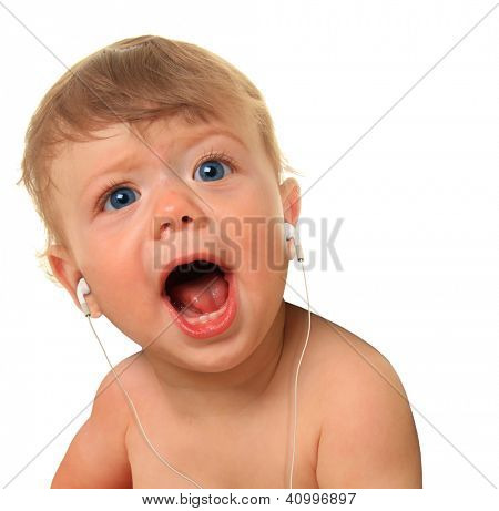 Ten month old baby boy listening to music on ear buds.