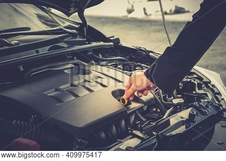 Young Man Trying To Fix His Broken Down Car On The Side Of The Road. Open The Hood See Engines That 