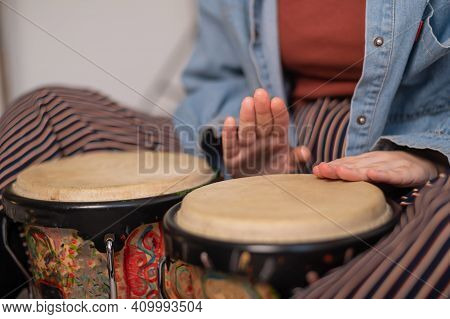 Young Faceless Caucasian Woman Playing Small Ethnic Drums