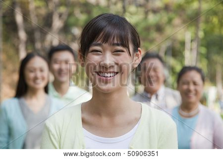 Multi generational family portrait, focus on teenage daughter