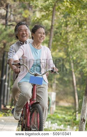 Older couple riding tandem bicycle, Beijing