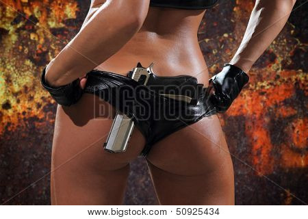 Sexy woman with gun over grunge background