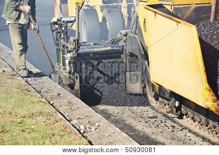 asphalt paver machine during urban road construction and repairing works