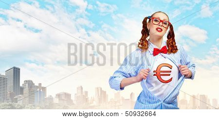 Young woman acting like super hero with euro sign on chest