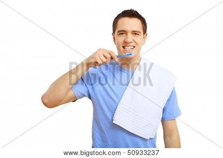 Young man in blue shirt brushing his teeth