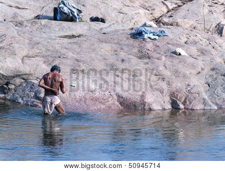 Man Standing In The Cold Water Of Betwa River Washing Himself.