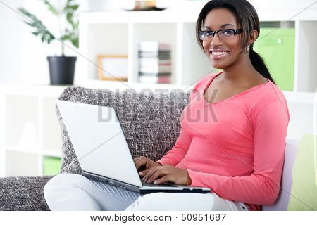 African woman using laptop at home