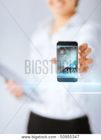 technology, internet, tv and news concept - woman hand with smartphone, videos and virtual screen