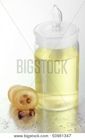 Ripe sliced grape and grapeseed oil, isolated on white