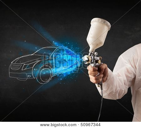 Worker with airbrush gun painting hand drawn white car lines