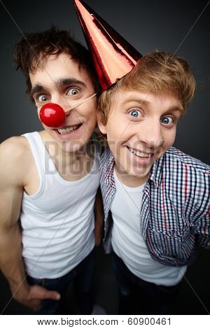 Two funny guys looking at camera and smiling crazily