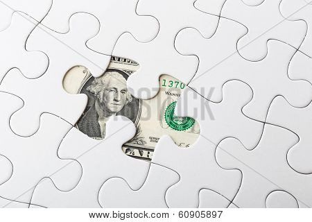 White puzzle and US banknote