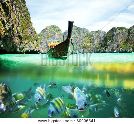 Underwater picture with fish and traditional longtail boat in Maya bay, Ko Phi Phi Le, Tailand