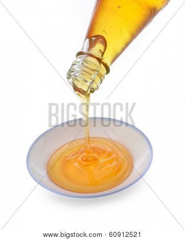 Honey being poured onto a plate.