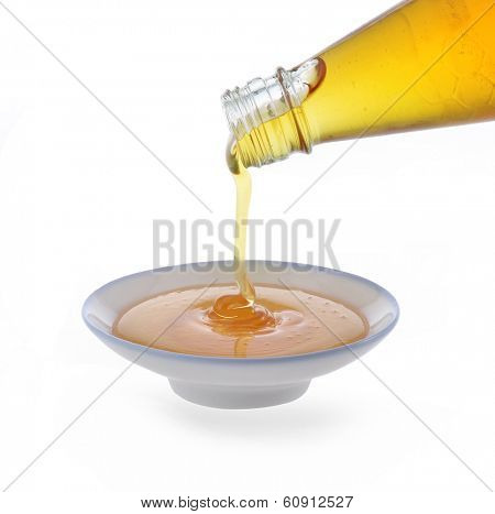 Honey being poured onto a plate.