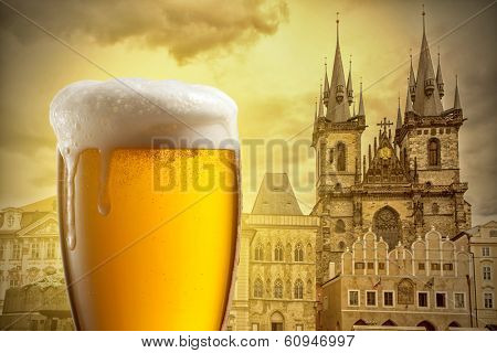 Glass of beer against Tyn Church in Prague
