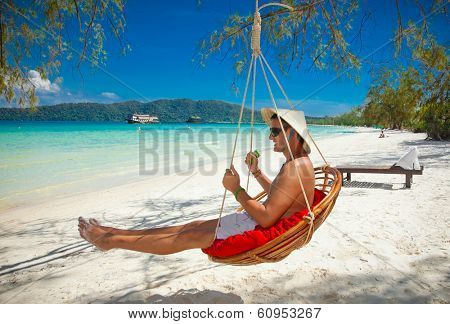 Man on a tropical beach at Koh Rong Samloem island  in Cambodia.