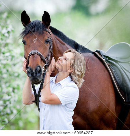 Woman hugging a horse.