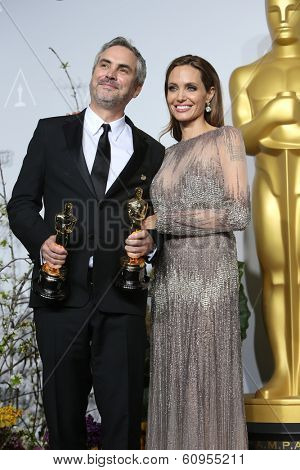 LOS ANGELES - MAR 2:: Alfonso Cuaron, Angelina Jolie  in the press room at the 86th Annual Academy Awards on March 2, 2014 in Los Angeles, California