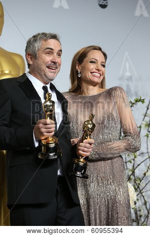 LOS ANGELES - MAR 2:: Alfonso Cuaron, Angelina Jolie  in the press room at the 86th Annual Academy Awards on March 2, 2014 in Los Angeles, California