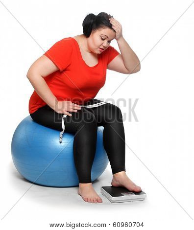 Overweight woman with weighing machine