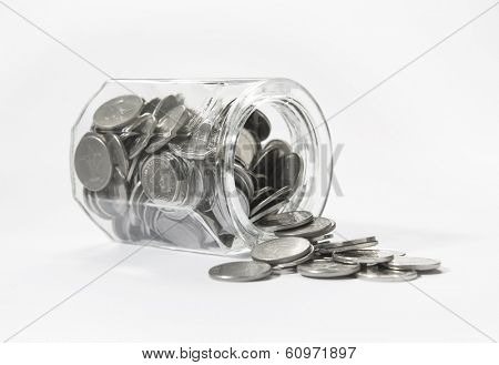 UAE Dirham coins spilling out of jar