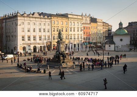 KRAKOW, POLAND - FEB 26, 2014: Adam Mickiewicz Monument in the Main Square. It dates to the 13th century, and at roughly 40,000 m it is the largest medieval town square in Europe.