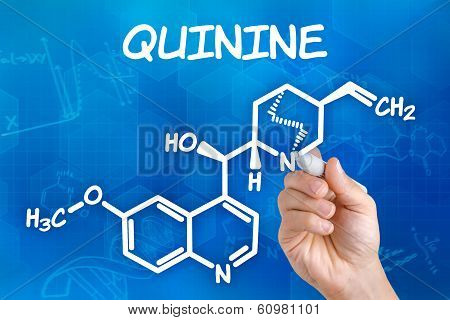 Hand with pen drawing the chemical formula of quinine