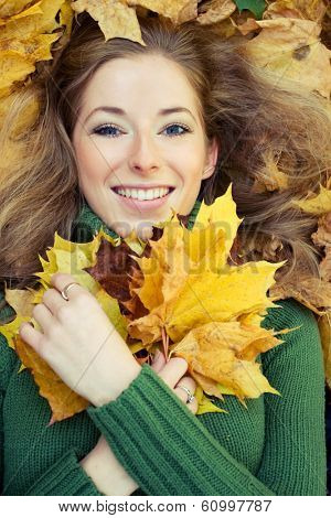 close-up portrait of young woman with marple leaves