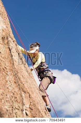 Senior Lady On Steep Rock Climb In Colorado
